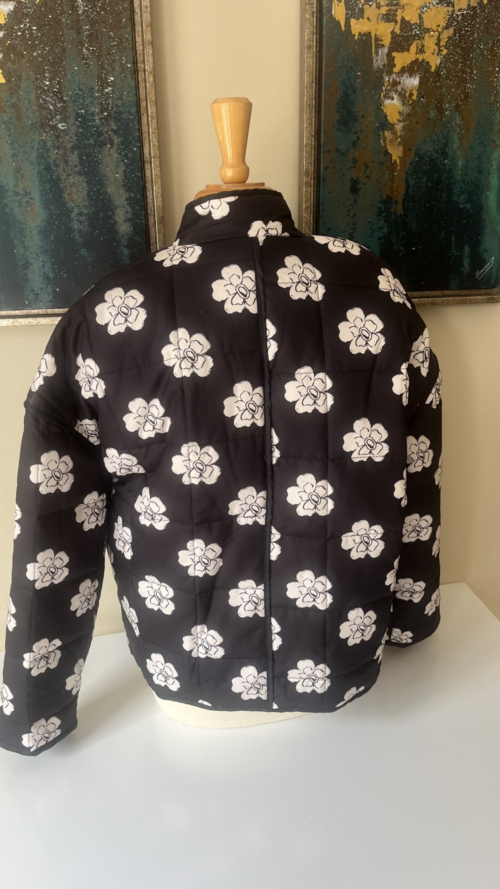 Black quilted jacket with white floral design