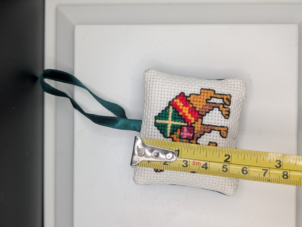 Cross-stitch camel Christmas ornament, made in Iraq