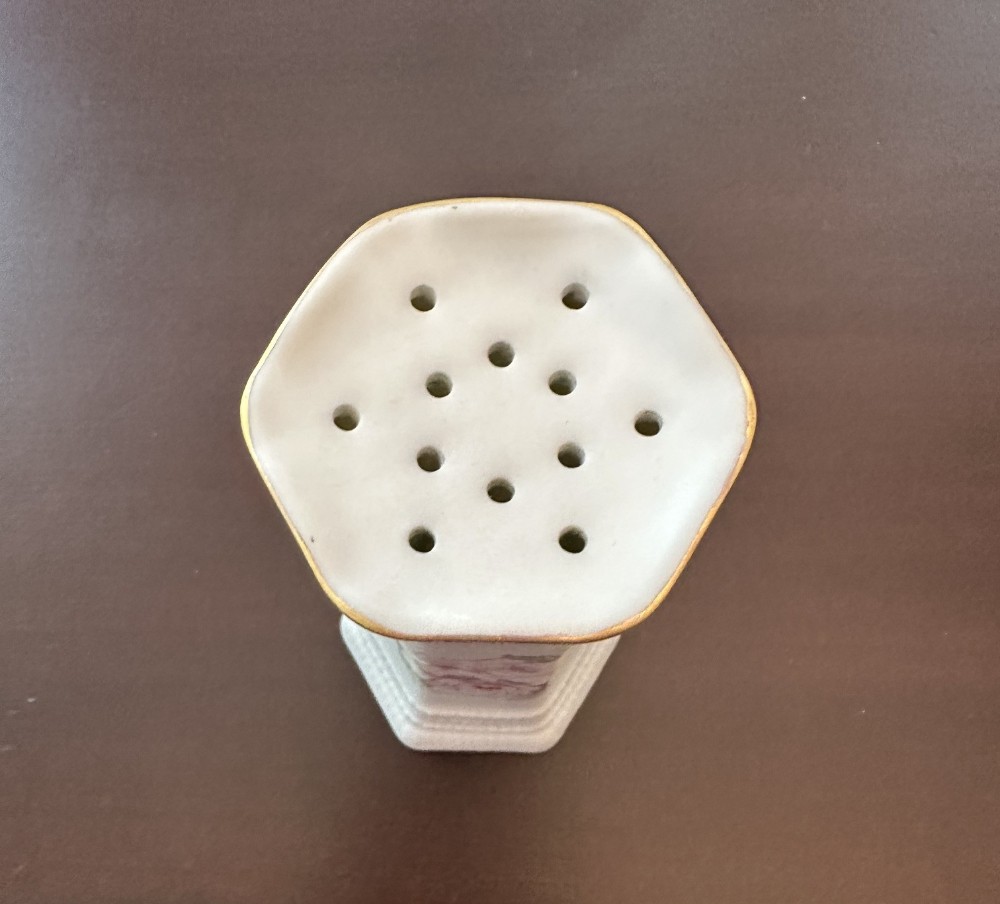Antique porcelain hat pin holder. Pink rose motif.