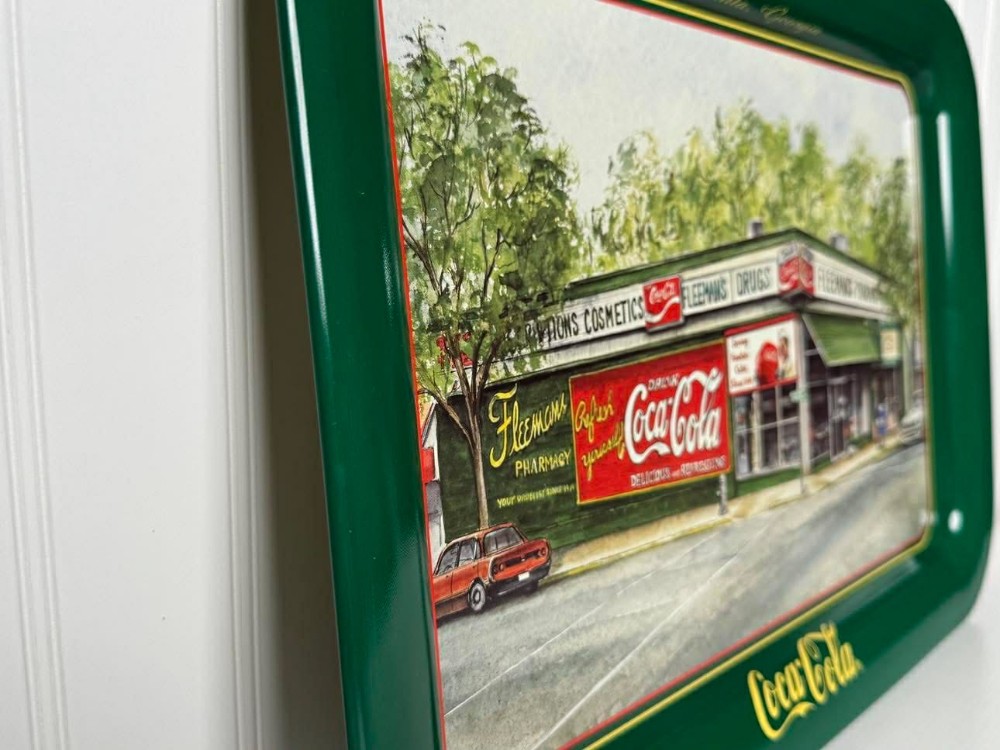 2676 - 1995 Coca-Cola serving tray of a watercolor painting of Fleeman's Pharmacy in Atlanta, Georgia, signed by artist Jeanne Mack..  Depicts the historic pharmacy and soda fountain that operated from 1914 to 1995