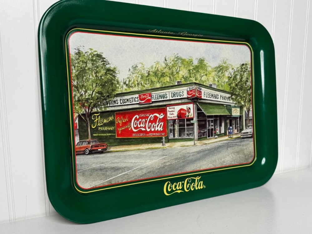 2676 - 1995 Coca-Cola serving tray of a watercolor painting of Fleeman's Pharmacy in Atlanta, Georgia, signed by artist Jeanne Mack..  Depicts the historic pharmacy and soda fountain that operated from 1914 to 1995