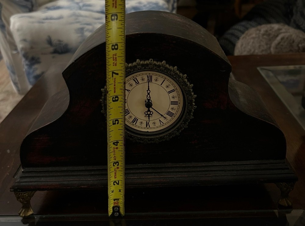 Dark wood mantle clock either Roman numerals