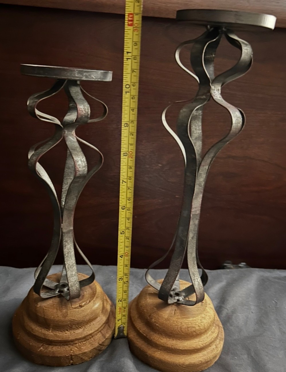 A pair of rustic  metal and wood candle