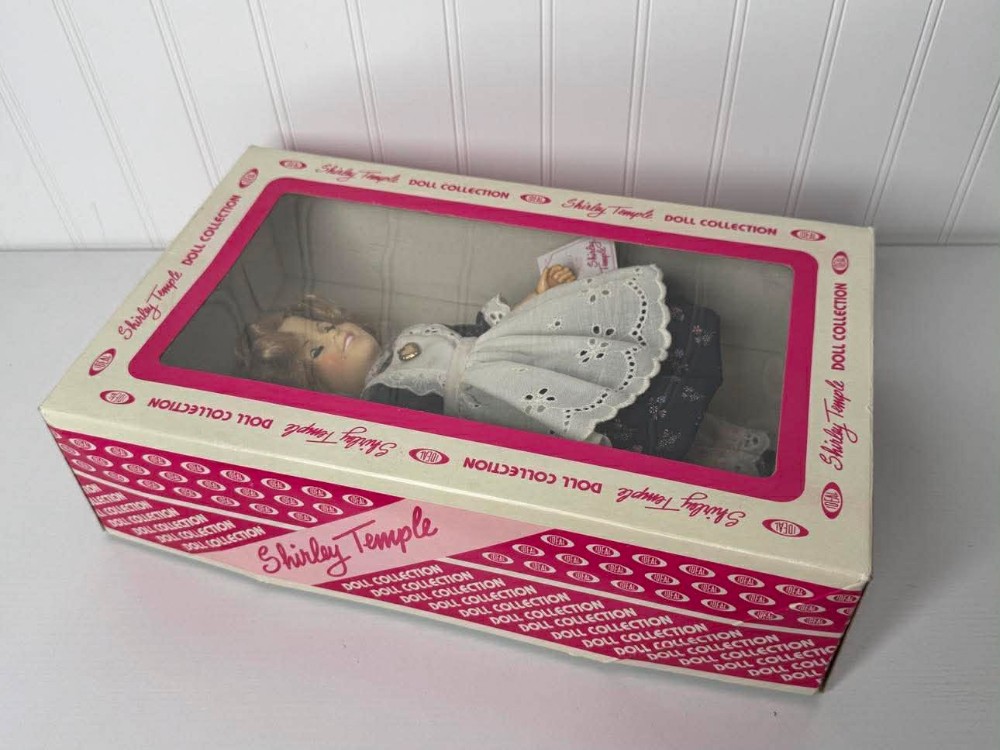2625 -  1982 Shirley Temple doll by Ideal is part of a collector's set, featuring a dress inspired by the movie 