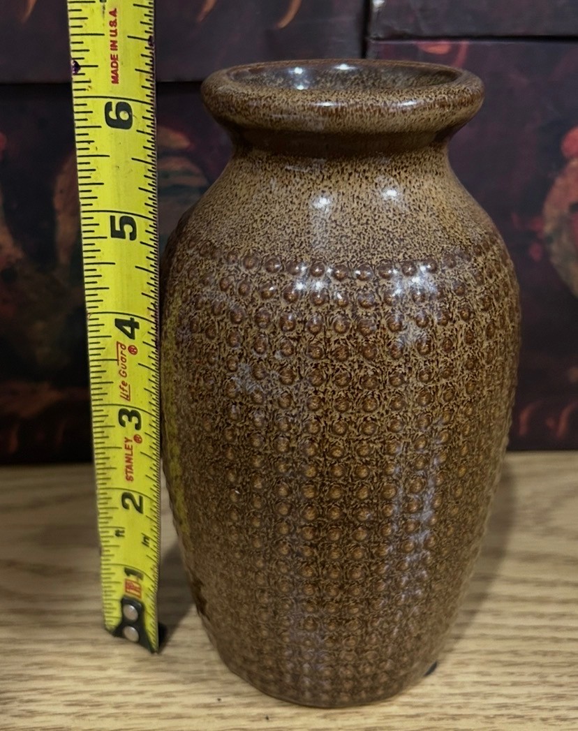 Brown ceramic vase with dot like texture