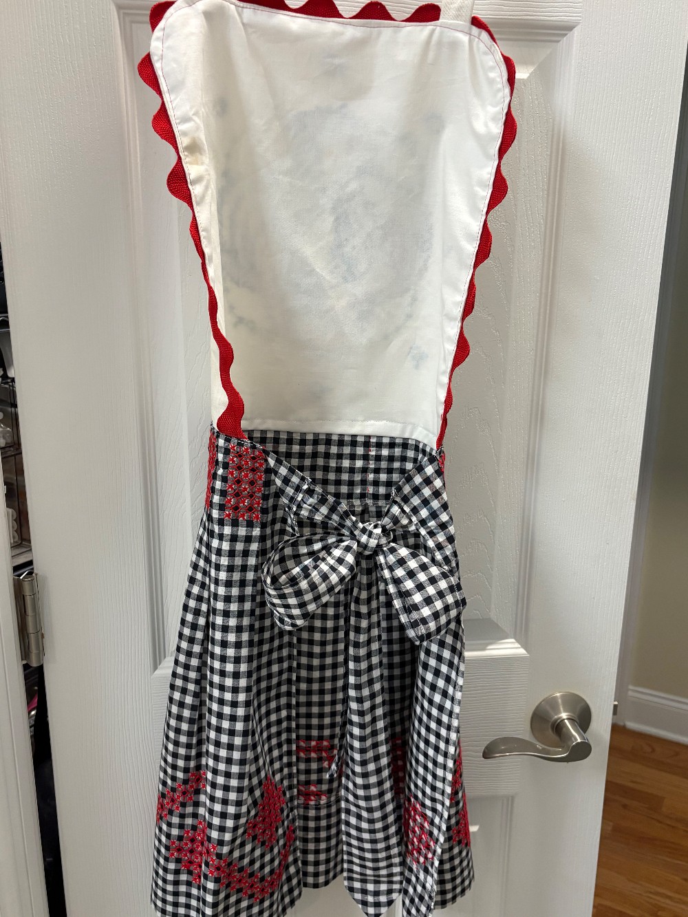Black and white gingham apron with a bib added that has an embroidered chicken