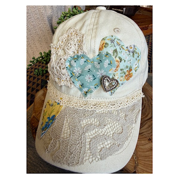 Hat: Cream ballcap w/appliqued hearts and heart brooch