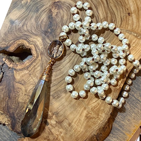 Elongated chandelier crystal  w/gold wrapped crystal topper on long knotted glass pearl strand .  Approx 38