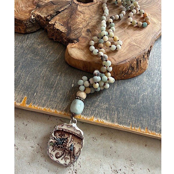 Broken china soldered pendant in vintage cream floral/birds w/ fossil stone & amazonite topper on long knotted matte Amazonite bead strand