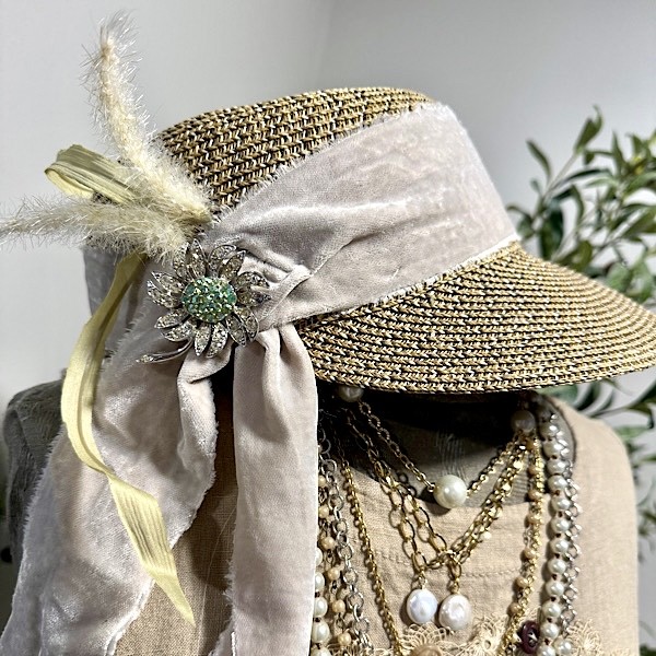 Hat: Straw hat in med brown w/front brim, rhinestone flower brooch, silk floral stems & light taupe velvet trim