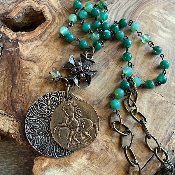 Layered medallions and textured cross hang from long bronze chain w/ linked green agate beads