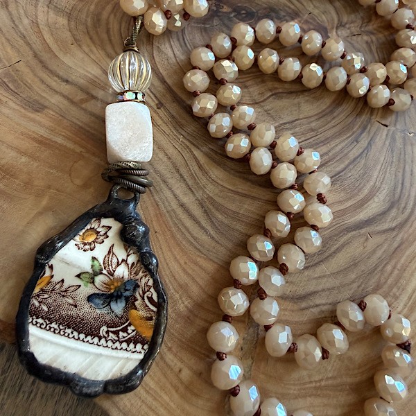 Broken china soldered pendant in vintage tones w/fossil stone & vintage lucite beads on long knotted champagne crystal bead strand
