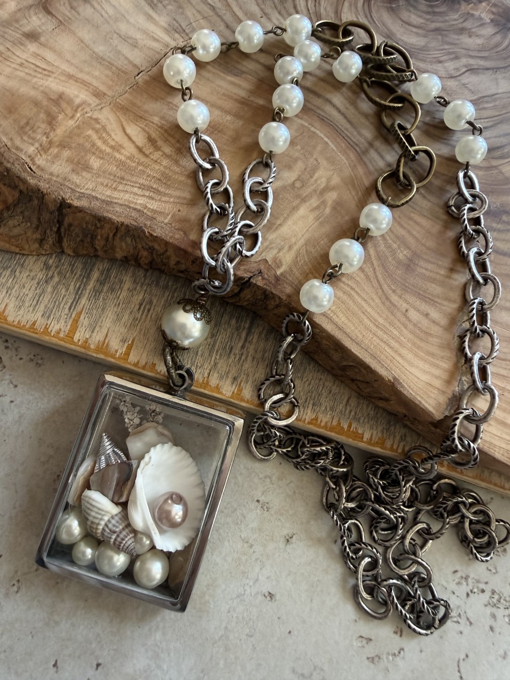 Memory pendant in silvertone w/shell & glass pearl collection on long mixed metal chain w/glass pearl accents.  Approx 35